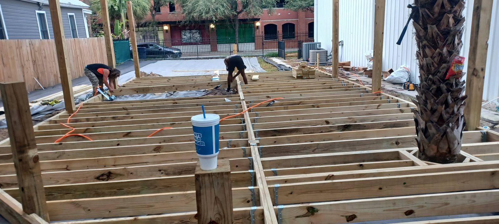 Piper Outdoors crew building a custom deck at sunset in Brevard County Florida